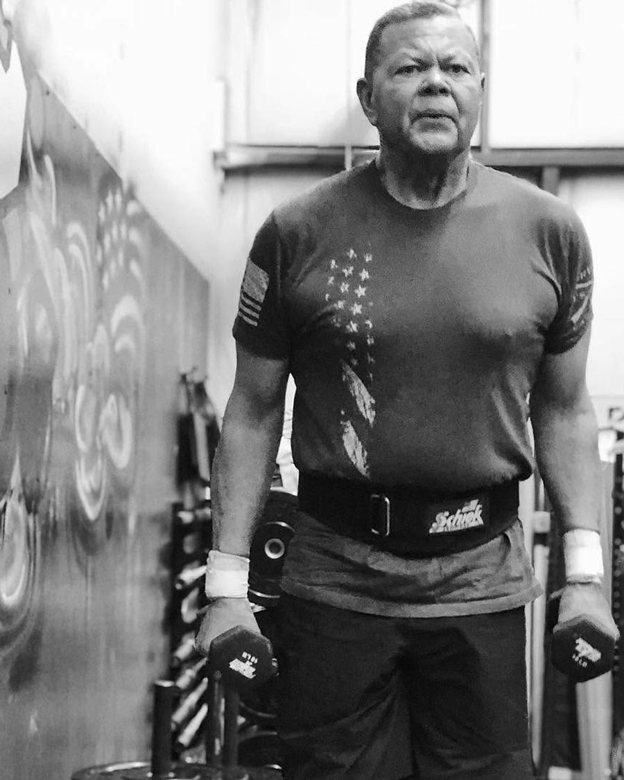 An older masters athlete setting up for a deadlift